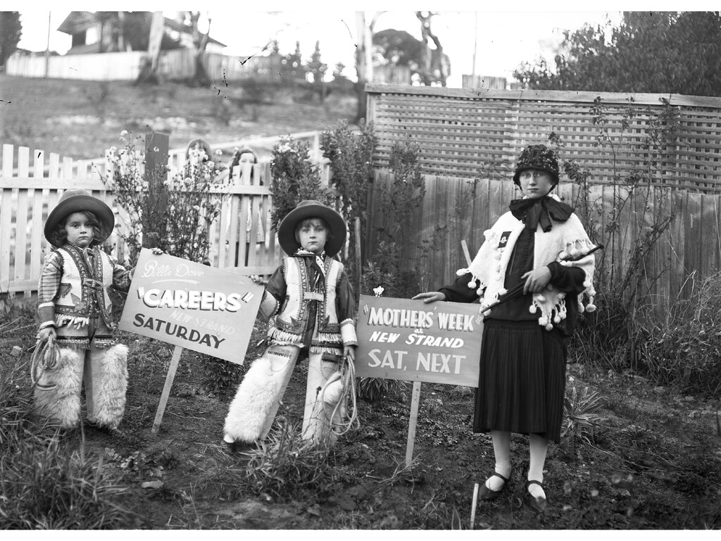 Children with posters advertising Mothers Week and Careers both showing at the New Strand Theatre, Liverpool Street, Hobart (1930)
