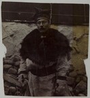 A man dressed in fur with a four winds hat on his head.