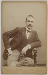 Photography studio portrait of Axel GallÃ©n with a cigarette, Helsinki, 1890.