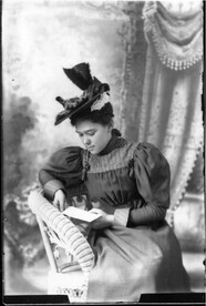 Portrait photograph of young woman reading letter n.d.
