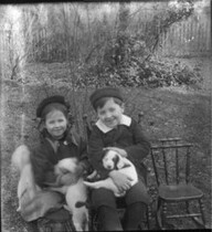 Boy and girl with puppies n.d.