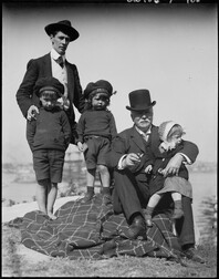 Dr Lindsay with Jean on his leg, Norman Lindsay with Jack & Ray, at Berrys Bay, ca. 1900-1912, by Lionel Lindsay
