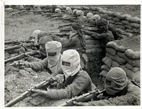 Indian infantry in the trenches, prepared against a gas attack [Fauquissart, France]. Photographer: H. D. Girdwood.