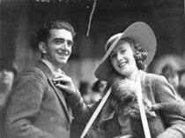 A United Charities worker selling a Rose Day button to a man, c. 1930s, by Sam Hood