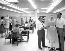 Alex Schneidman and Luther Powell inspect a sample dress at the Alix factory: Miami, Florida