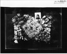 Memorial flowers and portrait of woman n.d.