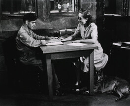 A blind woman teaching a blind man to read Braille