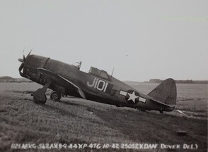 Republic P-47G Thunderbolt Republic P-47G-10CU, 42-25052 (built by Curtiss-Wright CO) is in a field at Dover AAFB. This photo shows it has a damaged aircraft a missing rear wheel, bent propeller, and it seems that the engine had been on fire.
